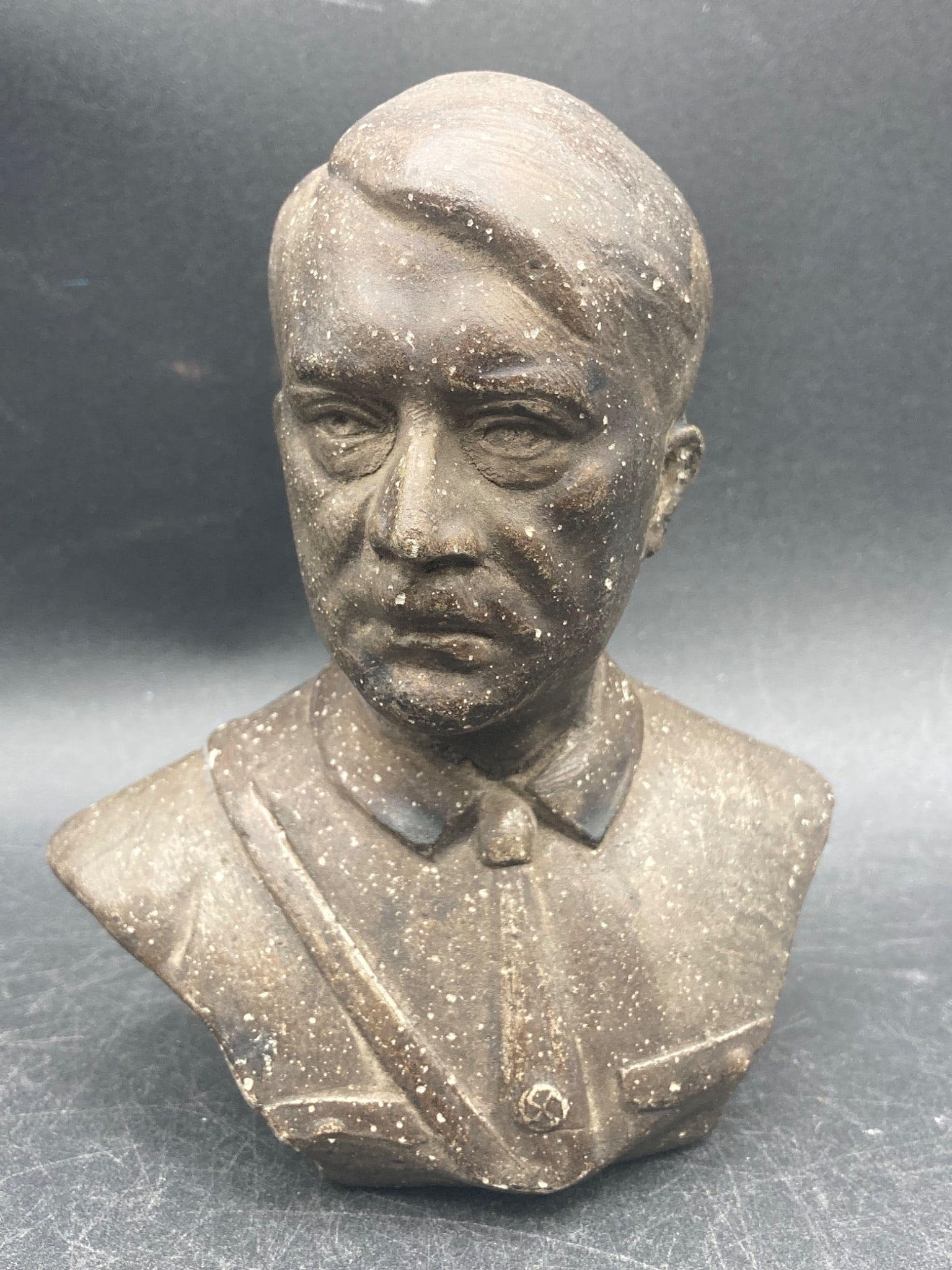 5-Inch Bronze Adolf Hitler Bust: This is a 5-inch bronze bust featuring Adolf Hitler with visible NSDAP markings. The item includes detailed sculptural representations of the subject's face and shirt, accompanied by a distinctive NSD