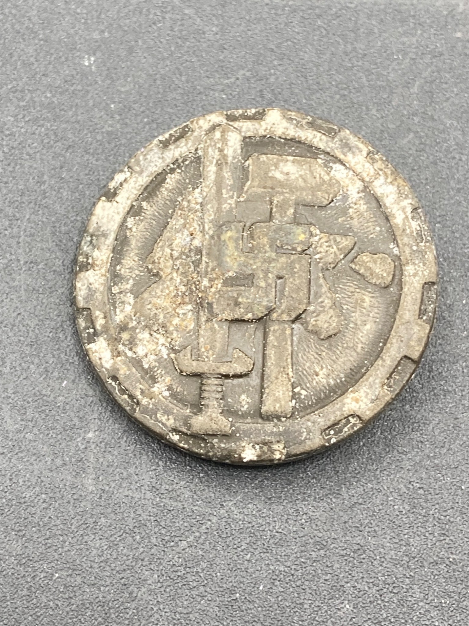 1938 German NSDAP Day Of Handicrafts Tinnie: This item is a 'Tag Des Deutschen Handwerks' tin badge from 1938. It features detailed German lettering and symbols on the reverse, with a functioning pin mechanism. Made to commemorate an NSDAP event