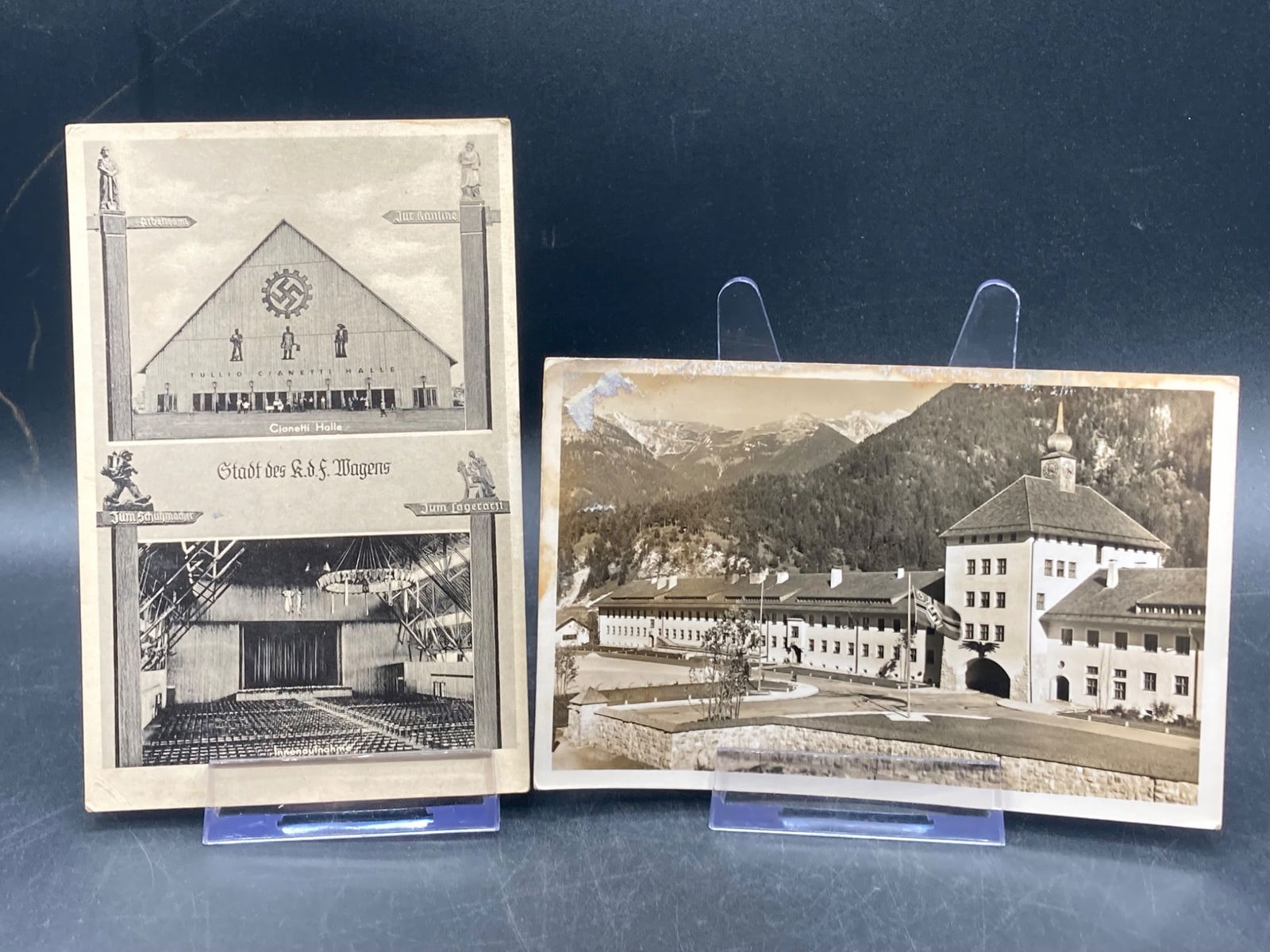 Two WWII German Postcards with Postmarks: This lot includes two WWII-era German postcards. The first postcard features imagery of a building with a swastika emblem and interior details of a hall, with a Deutsches Reich stamp and partial handw
