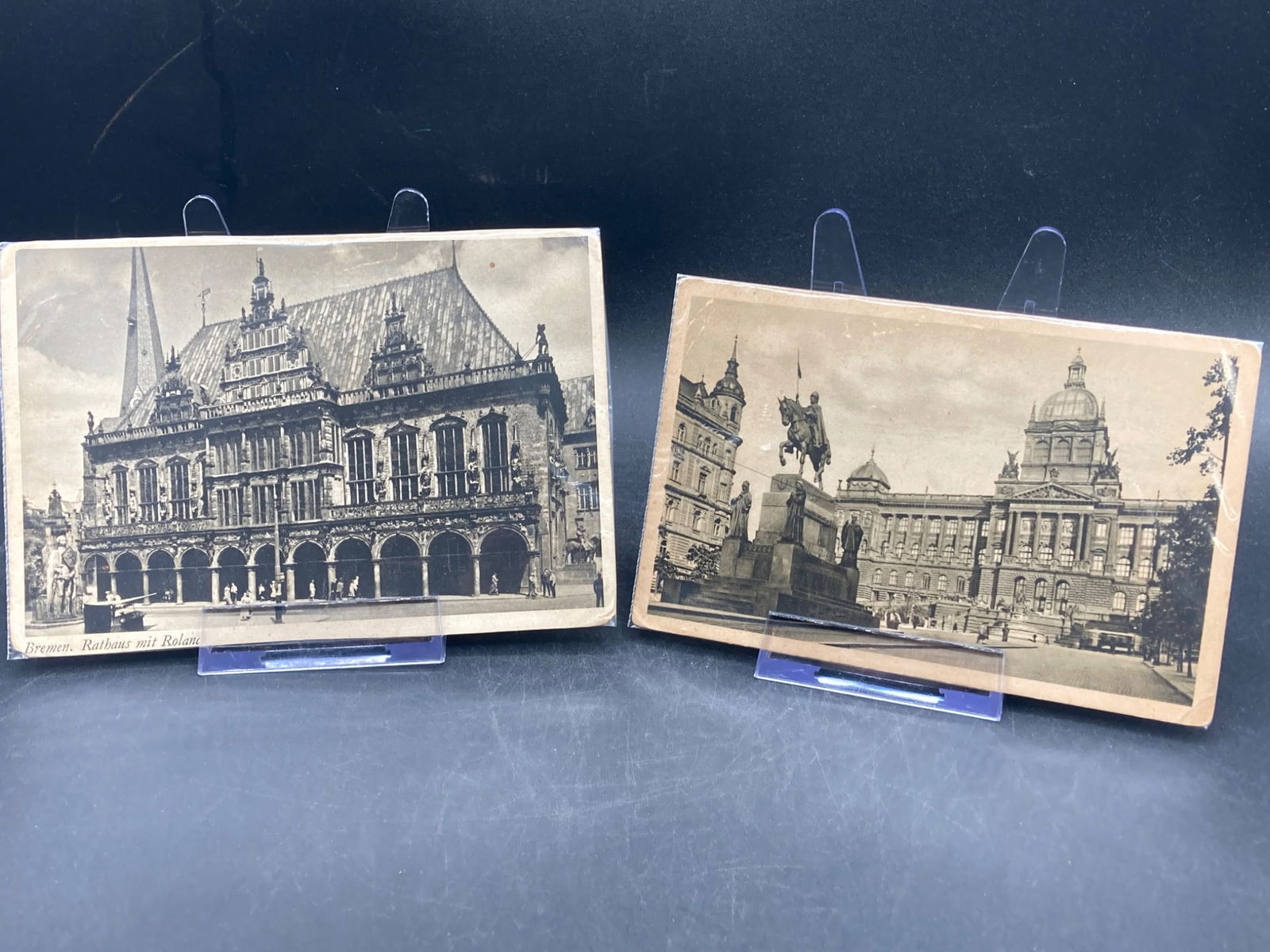 WWII Era German Postcards, Rathaus and Historic Monuments: A lot of two WWII-era German postcards featuring black-and-white and colored prints of historical cityscapes. The first card depicts Bremen Rathaus (Town Hall) and surrounding architecture, labeled 'B
