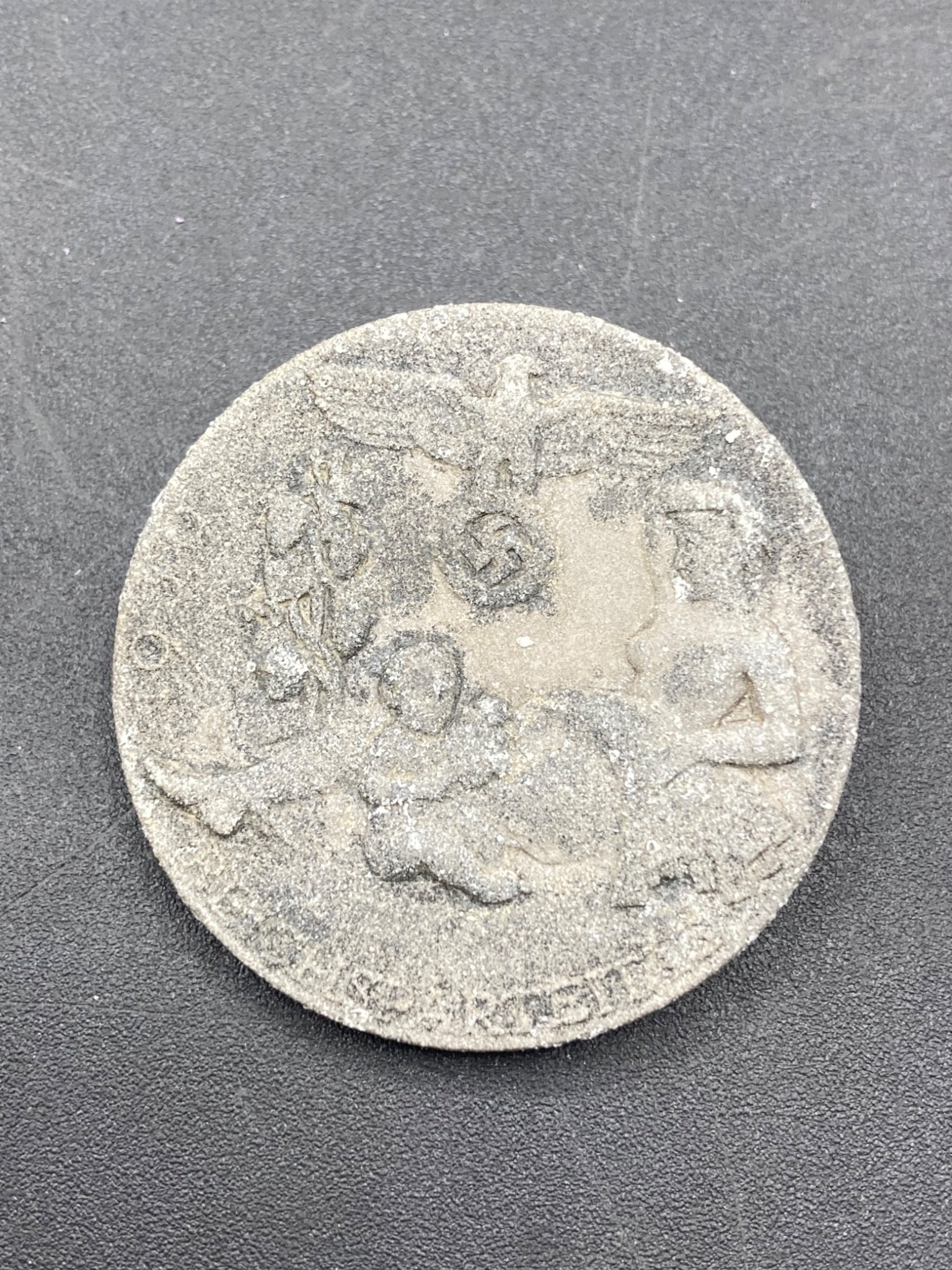 WWII German 1939 Reichsparteitag Tinnie Badge: This is a WWII-era German Reichsparteitag tinnie, dated 1939. The tinnie is zinc metal. The item features imagery of an eagle and swastika above stylized figures in relief. The back includes a functio