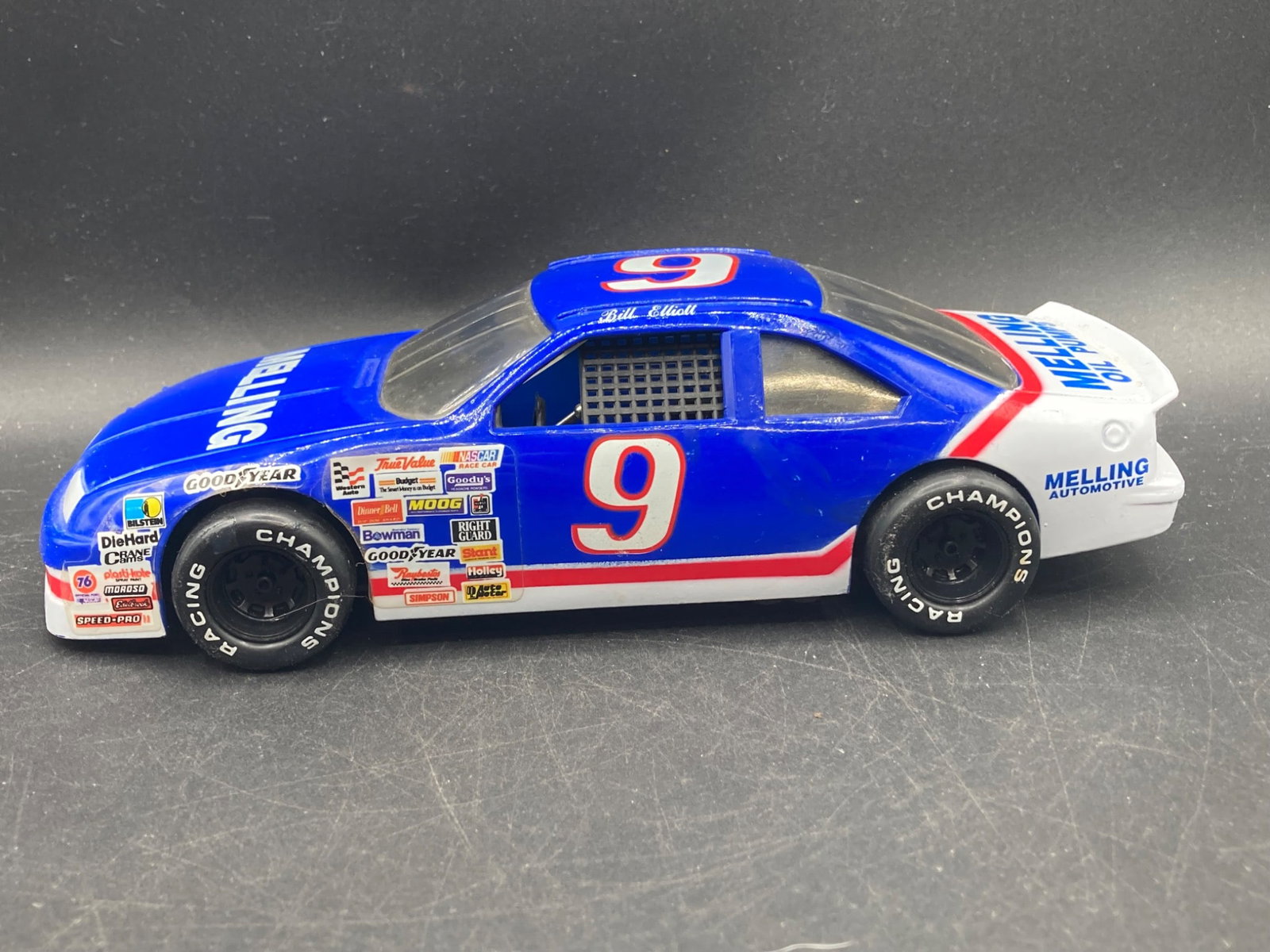1991 Racing Champions Bill Elliott 1/24 No. 9 Ford Diecast Car: This is a diecast model car of Bill Elliott's No. 9 Ford, manufactured by Racing Champions in 1991. 1/24 scale size. The car features detailed sponsor decals, 'Melling Oil Pumps' branding, and is made