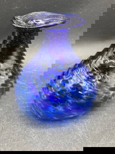 Cobalt Blue Swirled Glass Vase: A cobalt blue glass vase featuring a swirled pattern and a uniquely designed flattened rim. The item measures approximately 4 inches in height and displays a polished pontil mark on the base,
