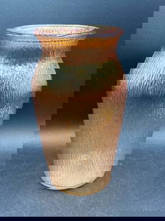 Carnival Glass Marigold Tree Bark Vase: This is a carnival glass marigold vase featuring the tree bark pattern. It has an iridescent finish that shimmers in varying tones. The vase measures approximately 8 inches in height. The base has a s