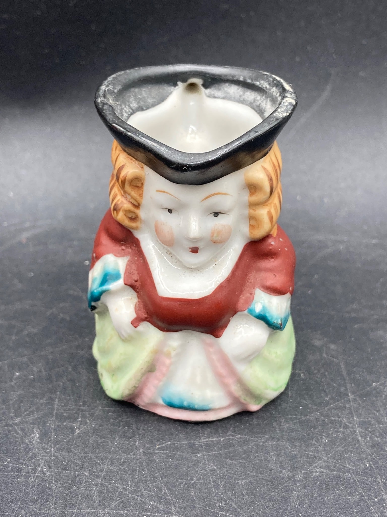 Vintage Occupied Japan Miniature Toby Mug: This miniature Toby mug, made in Occupied Japan, features hand-painted detailing and a colorful design. It portrays a figure wearing a detailed bonnet and attire, with a hollow interior and handle. Th