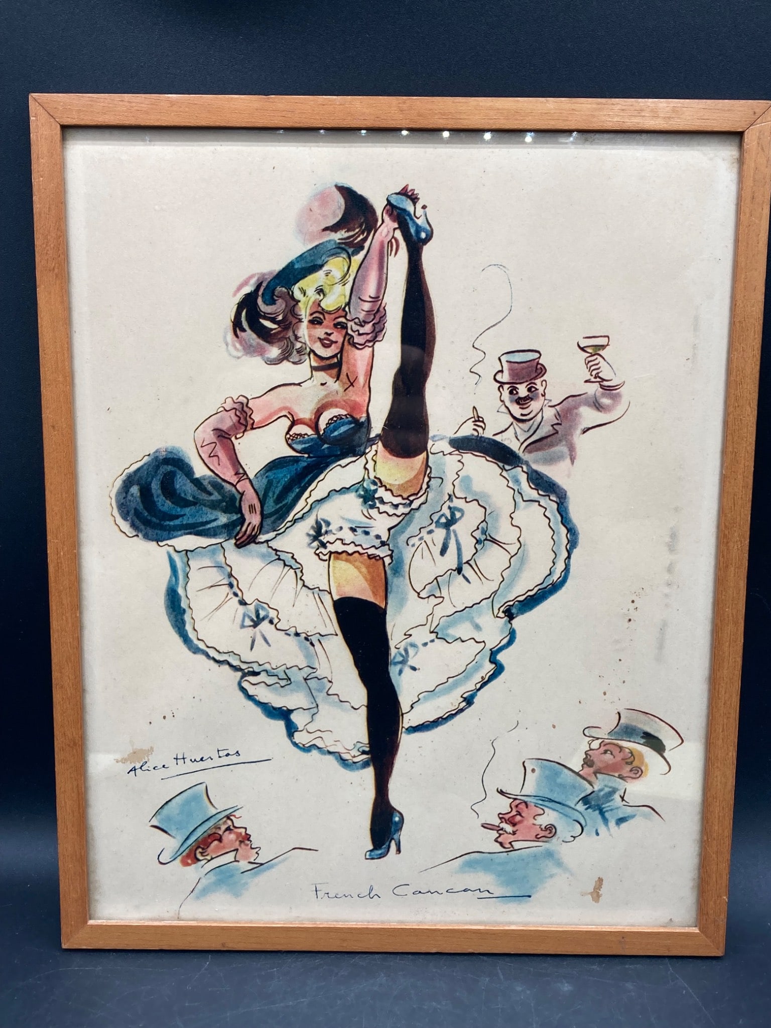 Alice Huertas ?French Cancan' Print: This is a print titled 'French Cancan' by Alice Huertas. The artwork is displayed within a wooden frame and measures approximately 12 inches in height and 10 inches in width (frame included). The prin