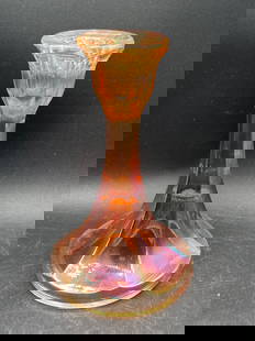 Carnival Glass Marigold Candle Holder: This item is a Carnival Glass candle holder in a marigold color featuring an iridescent finish. The item displays a flared top and a broad, slightly ridged base. Measurements and proportions relative