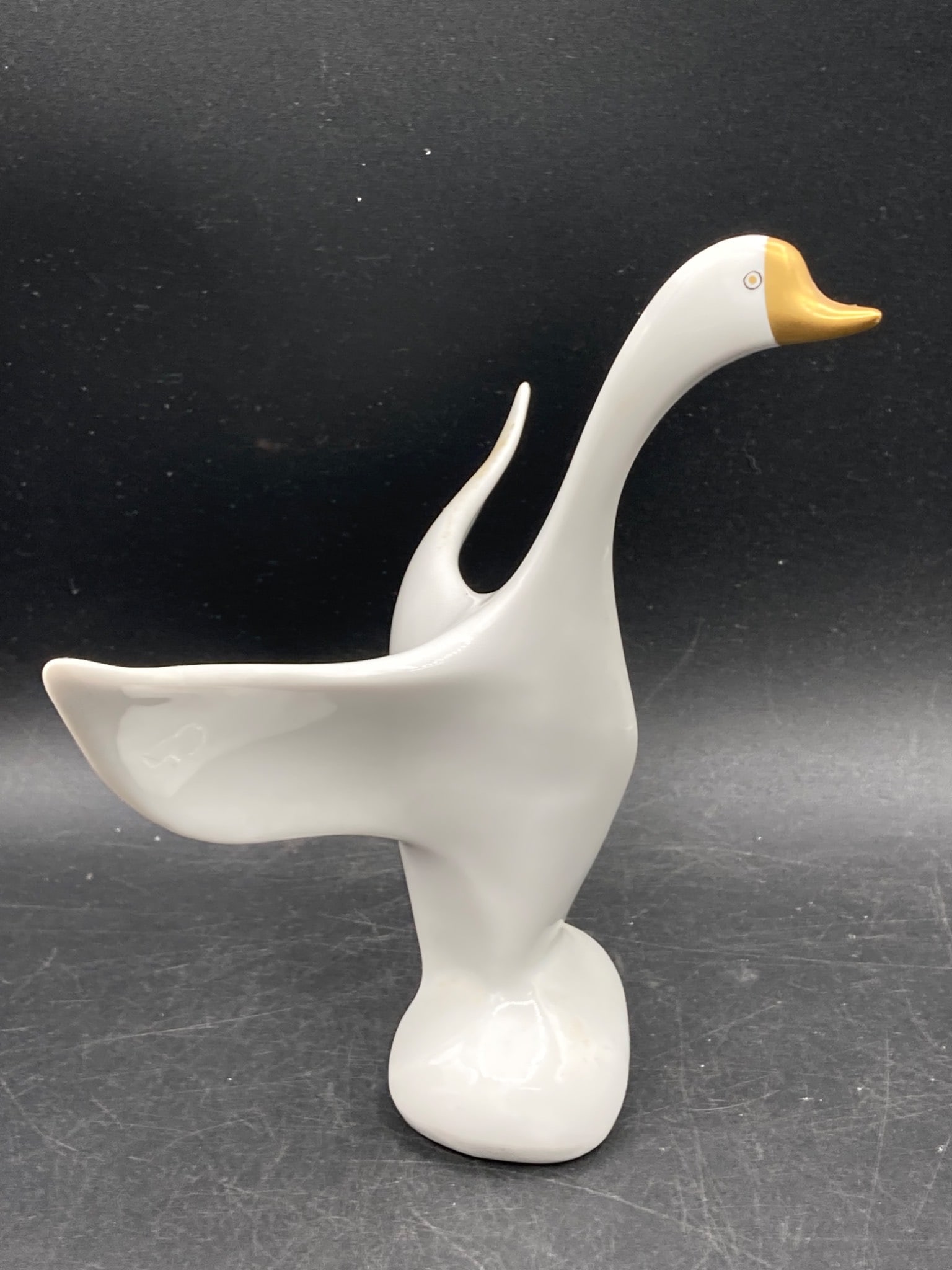 Hollóháza Hungarian Made Porcelain Swan Figure: This porcelain swan figure was crafted in Hungary by Hollóháza, a renowned porcelain manufacturer. The base is marked with the Hollóháza logo, 'Hungary,' and the number '183,' as well as 'HANDPAIN