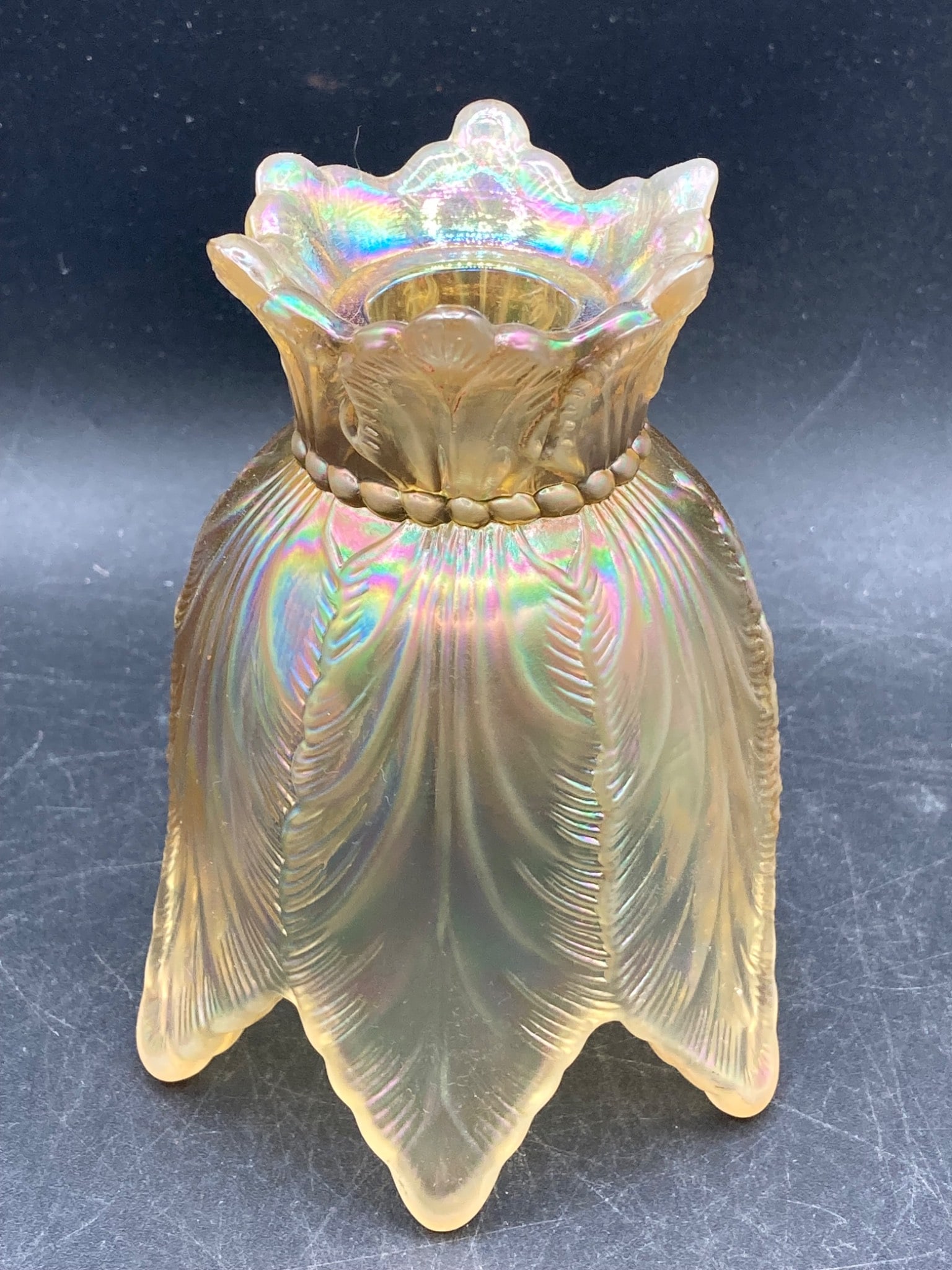 Fenton Glass Marigold Two-In-One Candle Holder: This Fenton Glass candle holder features a dual-purpose design, commonly referred to as a Two-in-One variant. Made with Marigold iridescent glass, the item is molded with intricate leaf-inspired patte