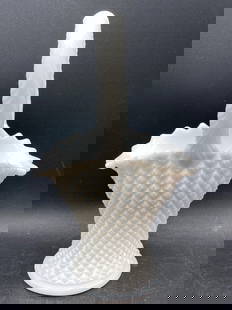 Milk Glass Diamond Pattern Basket: This is a white milk glass basket featuring a diamond pattern design throughout its body. It includes a decorative braided handle and a scalloped rim. The base showcases a starburst pattern, indicativ