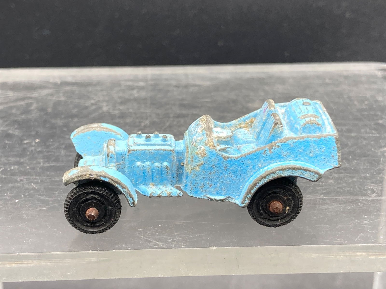 Vintage Tootsietoy Hot Rod Die Cast, Blue: This lot includes a vintage Tootsietoy Hot Rod die-cast model, featuring a blue paint finish.anifactured circa 1930s. The car measures approximately 2 inches in length and exhibits visible wear consis