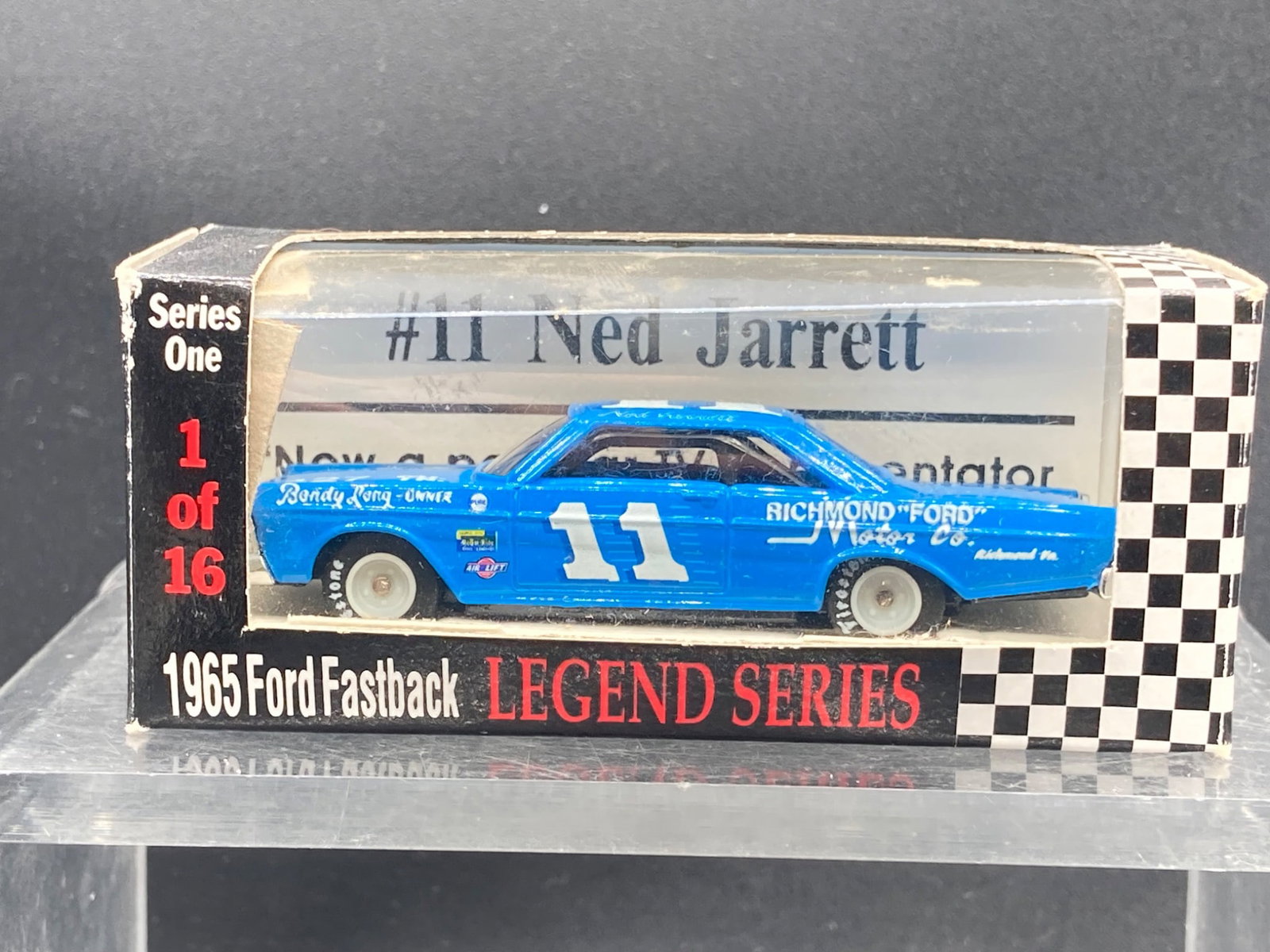 Racing Collectibles 1:64 NASCAR Ned Jarrett 1965 Ford Fastback Die-Cast Model: This is a Racing Collectibles 1:64 scale die-cast model from the Legend Series. It showcases #11 Ned Jarrett's 1965 Ford Fastback stock car. The packaging indicates it is part of Series One and is lab