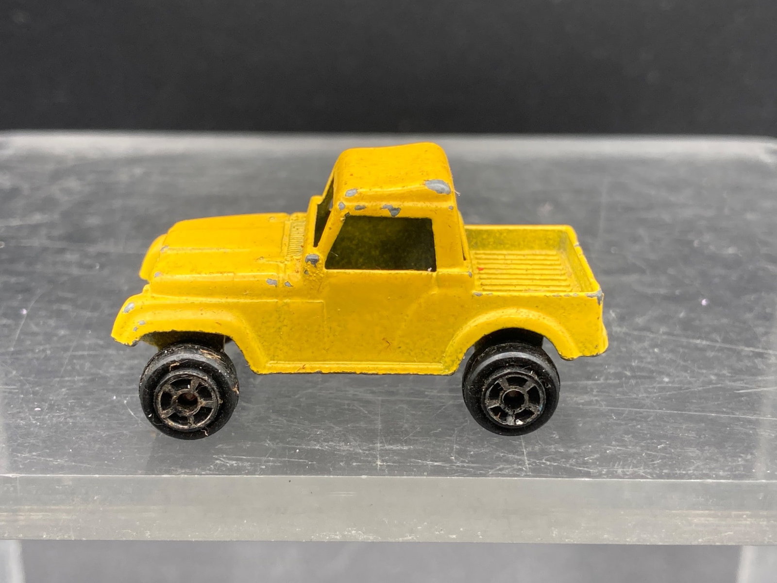 Tootsietoys Chevrolet S-10 Die Cast Toy, Yellow: This is a Tootsietoys Chevrolet S-10 die cast toy truck, painted yellow. The truck measures approximately 2 inches in length and is depicted in a pickup truck style. Stamped on the underside is 'Toots