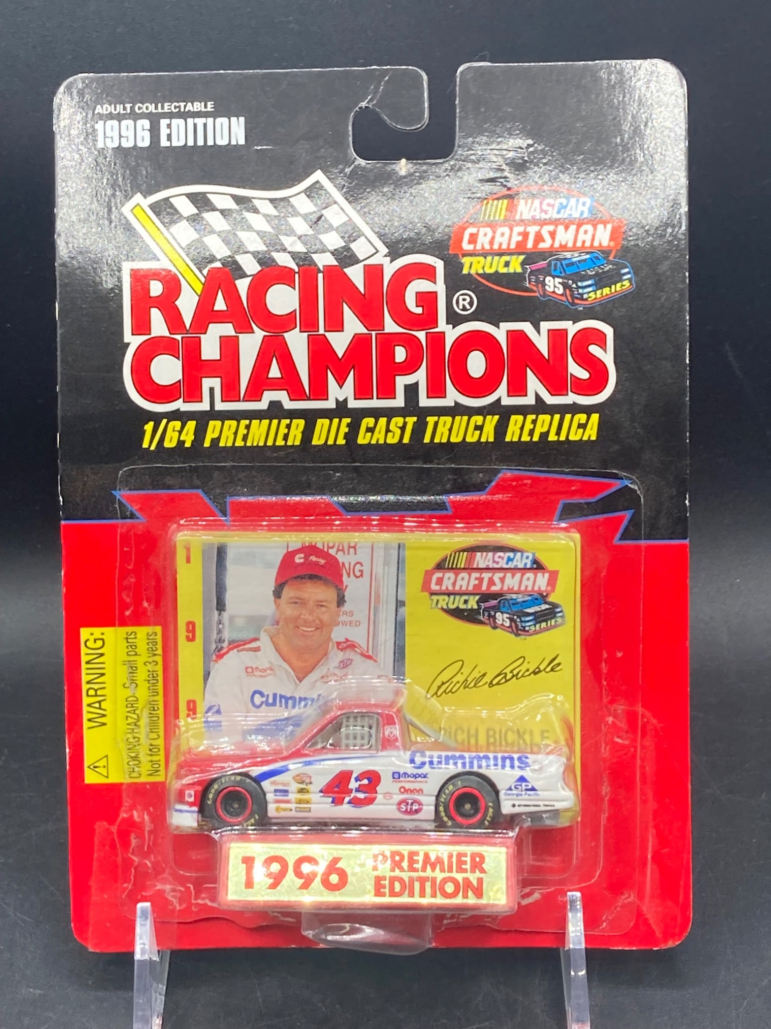 1996 Racing Champions Premier Edition 1/64 Die-Cast NASCAR Truck Replica – Rich Bickle #43: 1996 Racing Champions Premier Edition 1/64 scale die-cast replica of Rich Bickle's #43 NASCAR Craftsman Truck featuring Cummins sponsorship. Item remains sealed in original packaging, which includes a