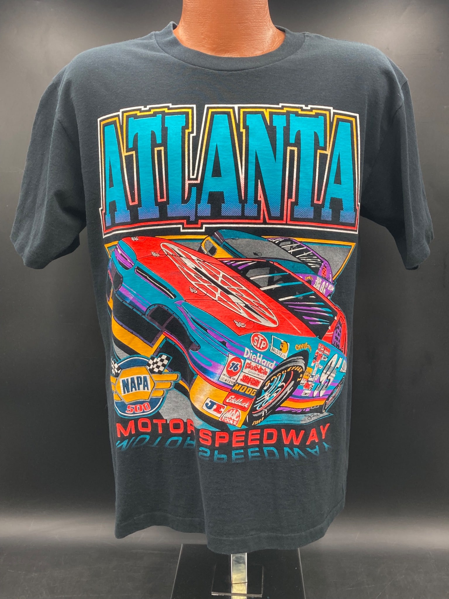 Vintage NASCAR Atlanta Motor Speedway NAPA 500 Shirt, Medium: This is a medium-size vintage NASCAR Atlanta Motor Speedway NAPA 500 shirt made by Belton. The shirt is 100 percent cotton, pre-shrunk, and manufactured in the USA. It features bold graphic designs on