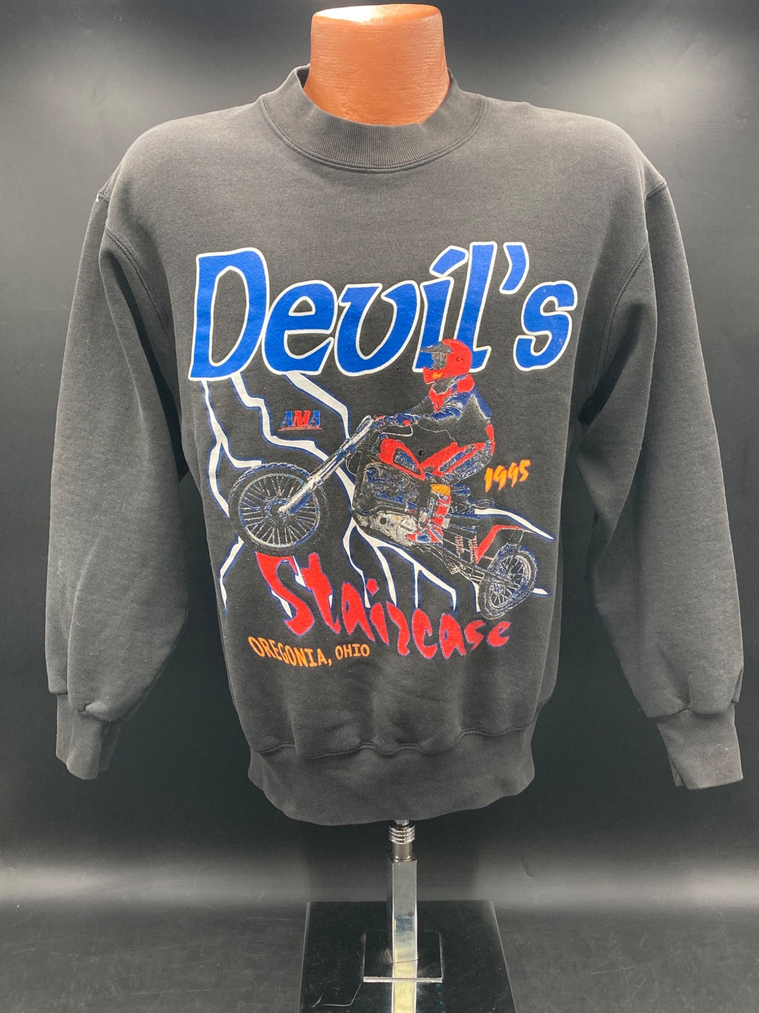 Vintage 1995 Devil’s Staircase Motorcycle Race Sweater, Medium: This is a black crewneck sweater commemorating the 1995 Devil's Staircase motorcycle race in Oregonia, Ohio. Made by Fruit of the Loom, the sweater is marked as adult size medium and composed of 50 pe