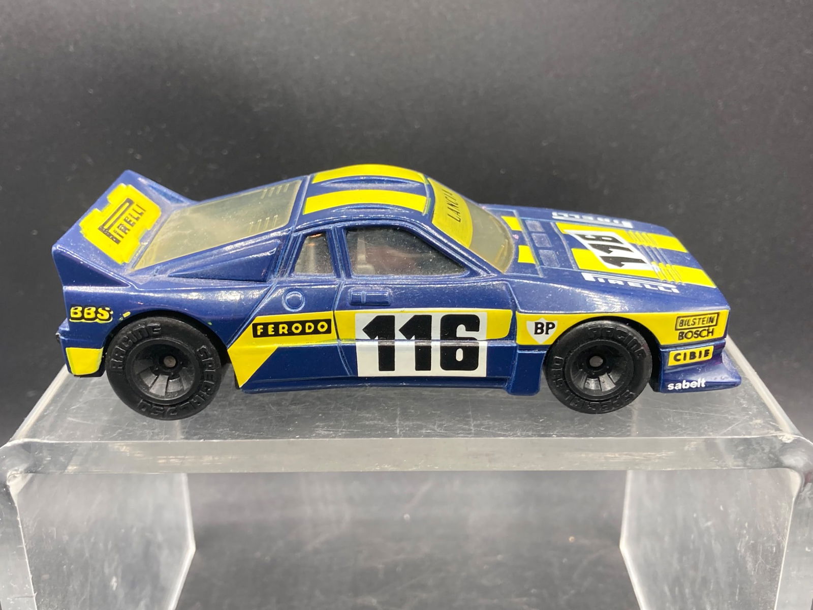 Matchbox Specials 1/40 Lancia Rally Die-Cast Car: Matchbox Specials 1/40 scale Lancia Rally die-cast model car. Features blue and yellow racing livery with detailed decals such as ‘Pirelli’, ‘Ferodo’, and ‘116.’ Manufactured by Matchbox I