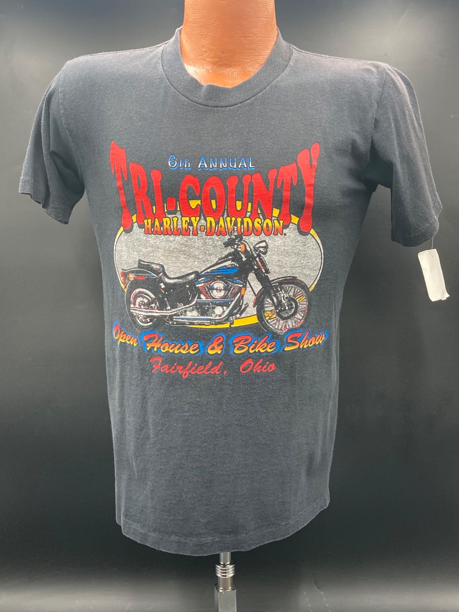 1991 Harley-Davidson Tri-County Event T-Shirt, Fairfield Ohio: Harley-Davidson event t-shirt commemorating the 8th Annual Tri-County Open House & Bike Show in Fairfield, Ohio. Features front graphics with a motorcycle and back graphics with the Harley-Davidson lo