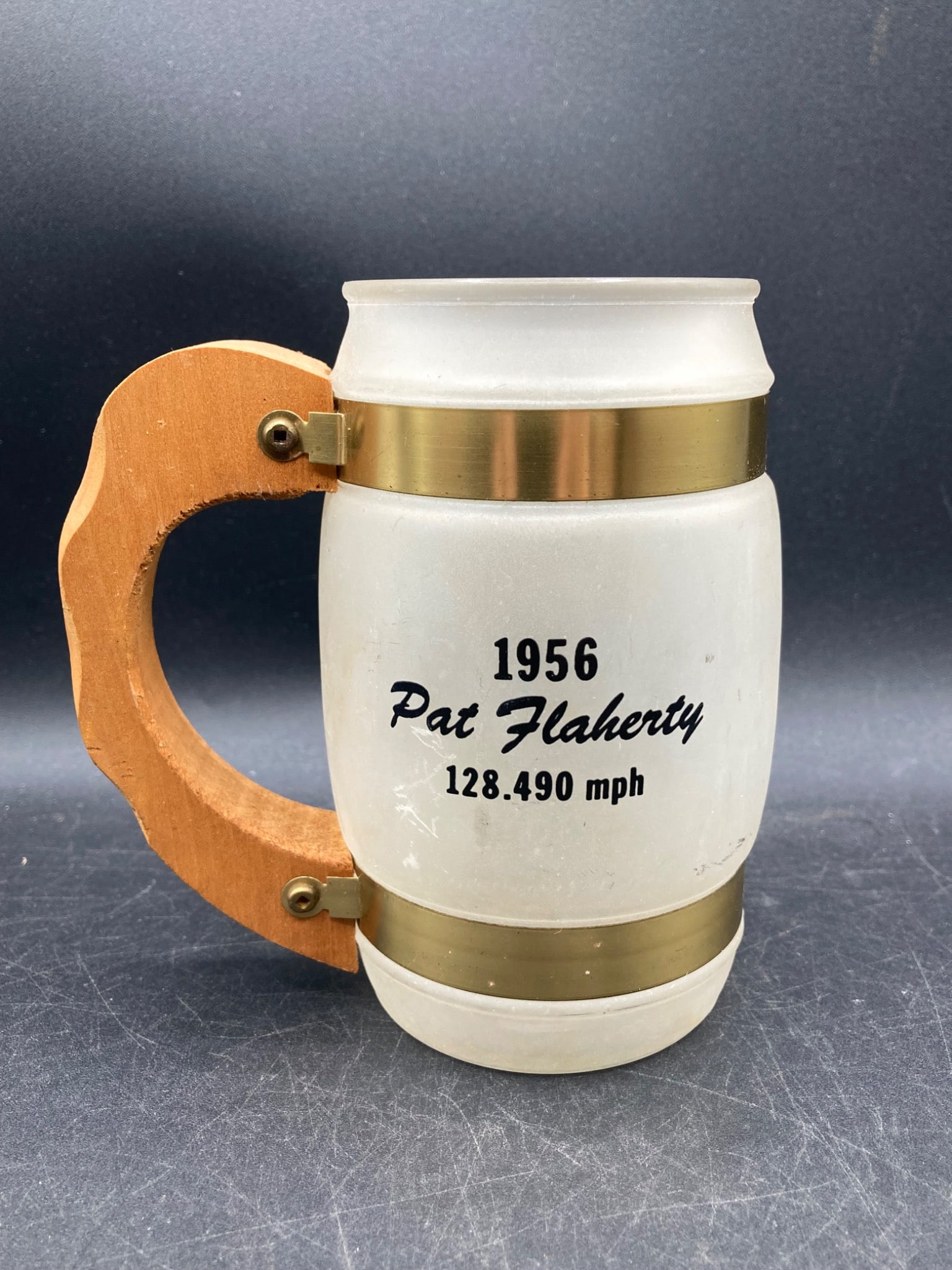 Siesta Ware 1956 Indy 500 Winner Pat Flaherty Mug: This is a Siesta Ware commemorative mug featuring the 1956 Indianapolis 500 winner Pat Flaherty. The mug displays '1956 Pat Flaherty 128.490 mph' and 'John Zink Special' with a graphic of a race car.