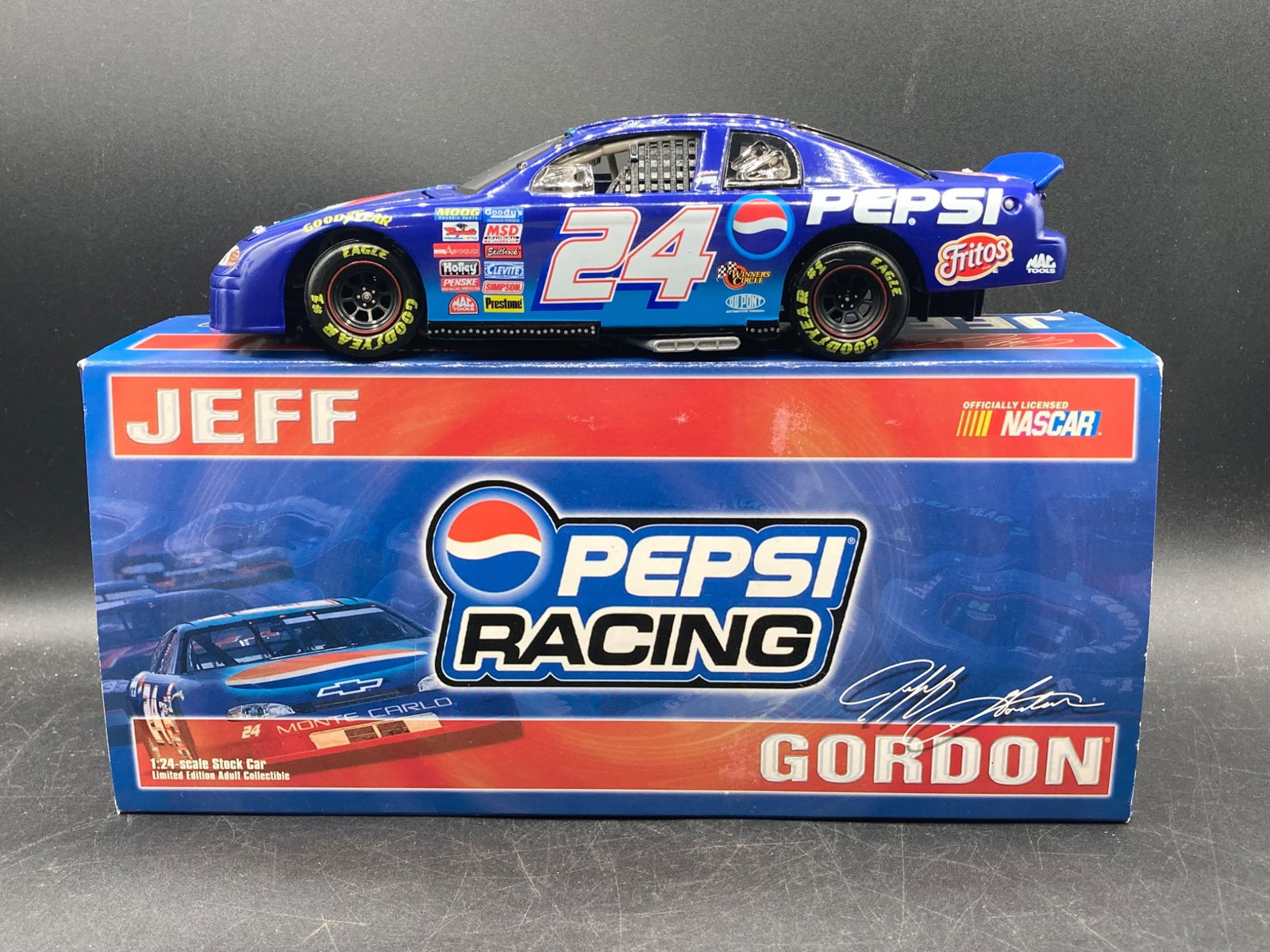 Action Racing 1/24 Jeff Gordon Pepsi NASCAR Die-Cast Model: This 1/24 scale die-cast car by Action Racing features Jeff Gordon’s No. 24 Pepsi Chevrolet Monte Carlo. The model includes authentic sponsor logos such as Fritos, Pepsi, and Goodyear, with intricat