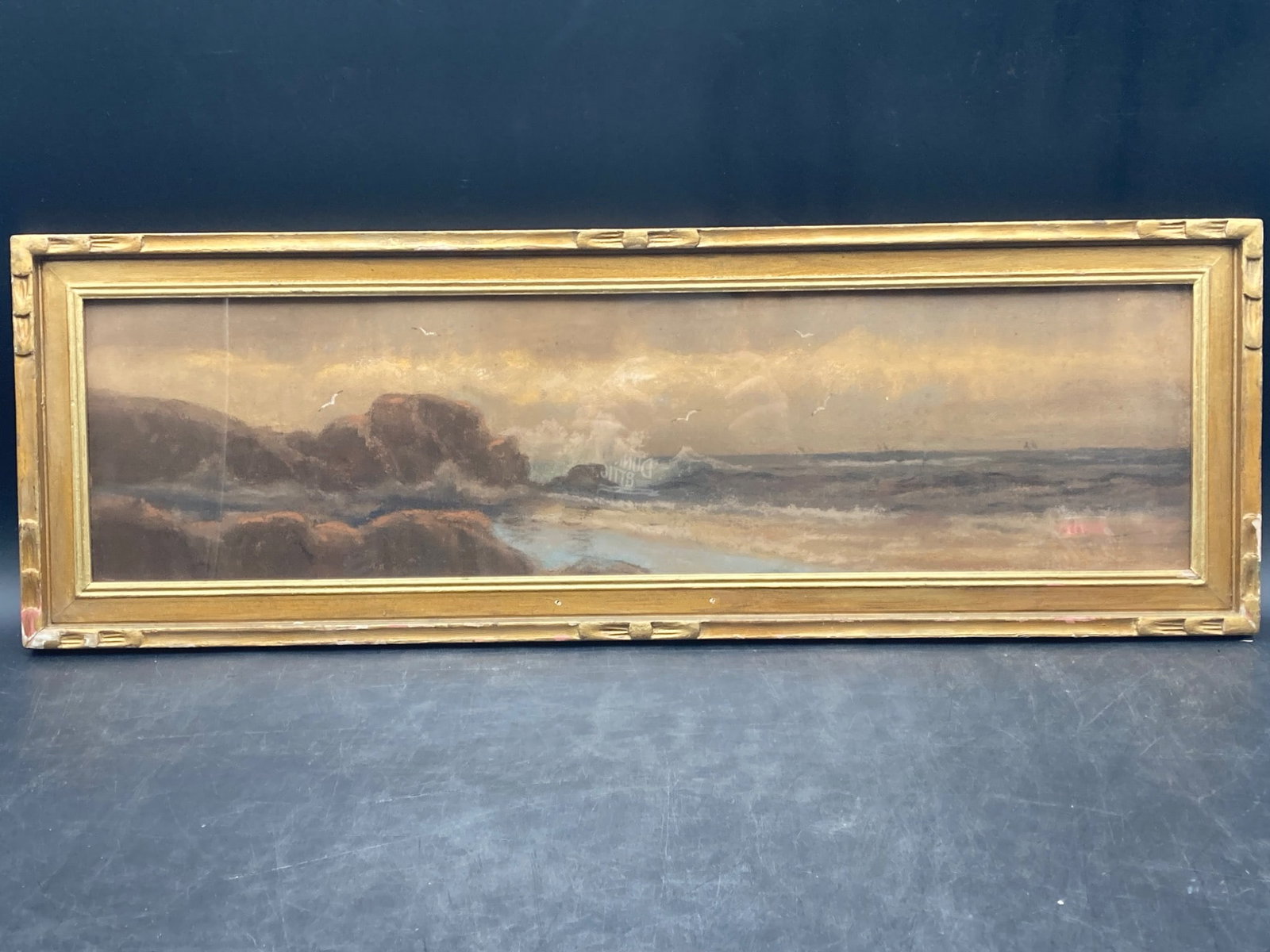 Framed Stormy Seas Landscape Watercolor Painting, Framed: This item is a framed watercolor painting depicting a stormy seas landscape. Dimensions are approximately 28 inches wide by 10 inches high including frame. Artwork includes visible waves, rocks, and s