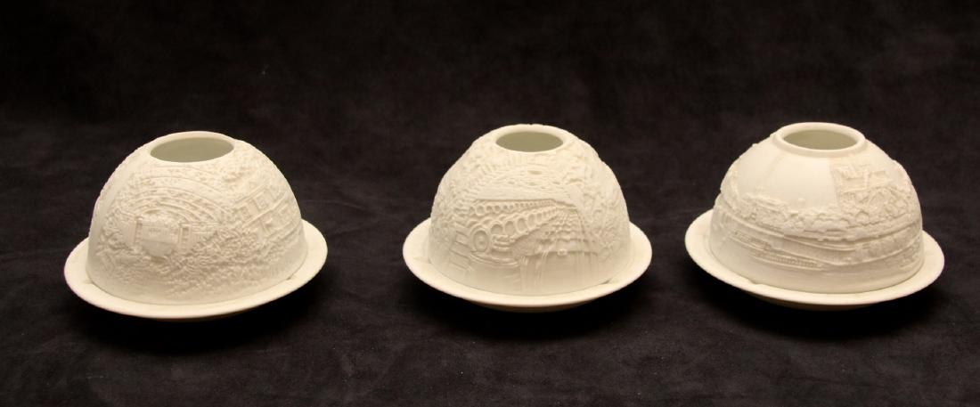 GROUP OF BERNARDAUD CANDLE HOLDERS: (3) BERNARDAUD PORCELAIN CANDLE HOLDERS. EMBOSSED SCENES. DIMENSIONS: 4 1/2" x 3"