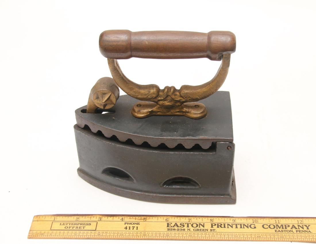 Charcoal iron with black enamel surface, dolphin posts: Charcoal iron with black enamel surface, dolphin posts Dimensions: 7”