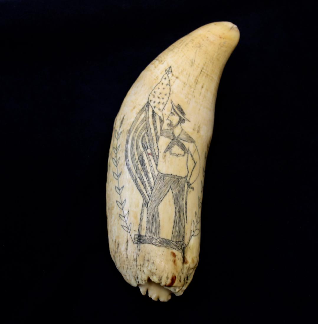 19TH CENTURY WHALES TOOTH SCRIMSHAW: SCRIMSHAW WHALES TOOTH DEPICTING SAILOR WITH AMERICAN FLAG - OTHER SIDE HAS A COMPASS STAR - EARLY TOOTH WITH GOOD PATINA 7"