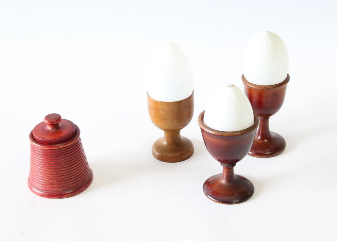 GROUP LOT OF COUNTRY SMALLS: INCLUDING (3) TURNED WOOD EGG CUPS, (3) GLASS EGGS AND TURNED WOODEN MATCH STRIKER - PAINTED RED
