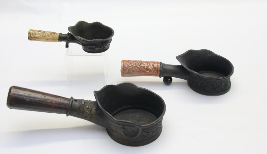 LOT OF CHARCOAL IRONS: (3) CHINESE PAN IRONS WITH BONE AND WOOD HANDLE 1- MARKED CHINA 7.25 TO 12"