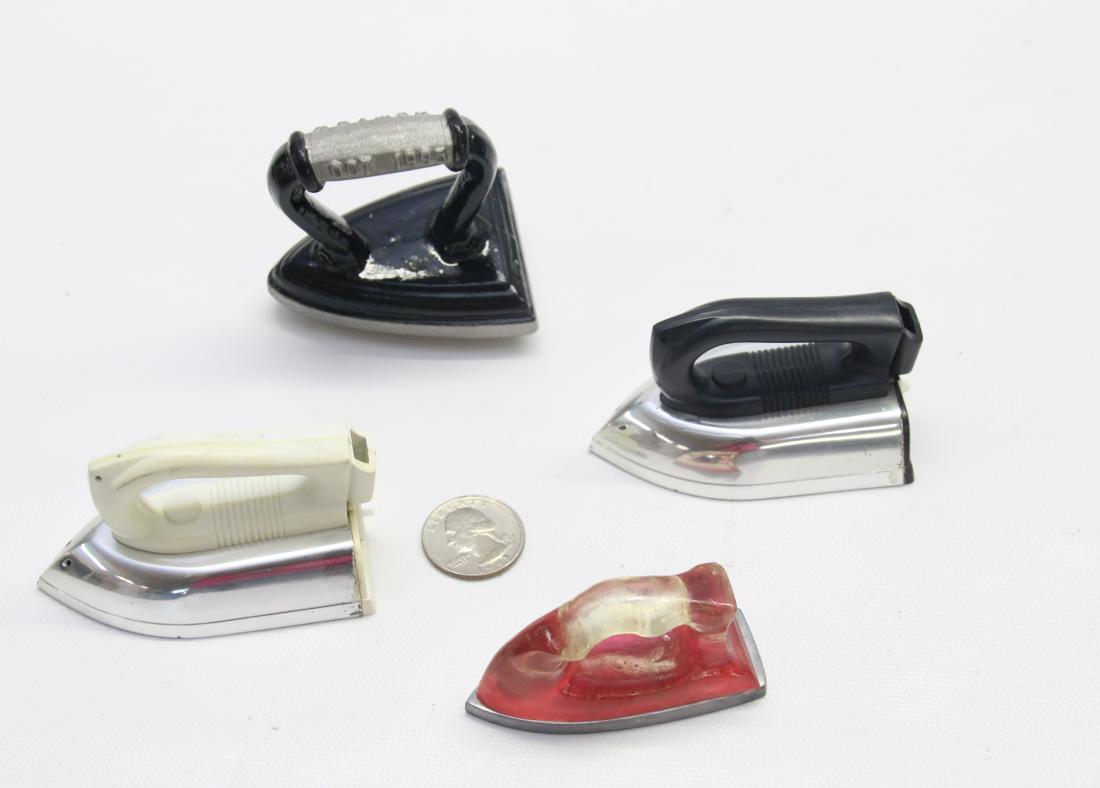 GROUP LOT OF MINIATURE IRONS: (4) INCLUDING - (2) PLASTIC , ONE MARKED 1995 NEWARK, AND ONE MARKED 1998 2 1/2" TO 3"