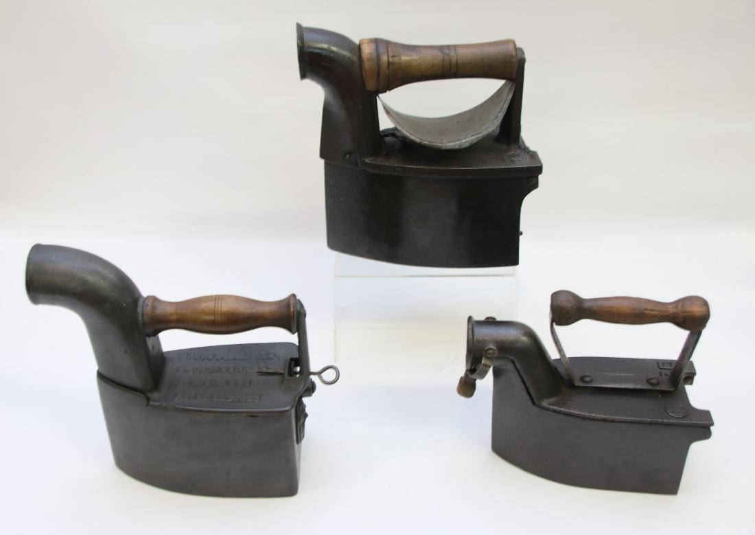 LOT OF CHARCOAL IRONS: (3) INCLUDING - ONE WITH A TALL BENT CHIMNEY (EUROPEAN), SPLIT CHIMNEY (PORTUGAL), TALIAFERRO & CUMMINGS TALL CHIMNEY WITH VULCAN DAMPER