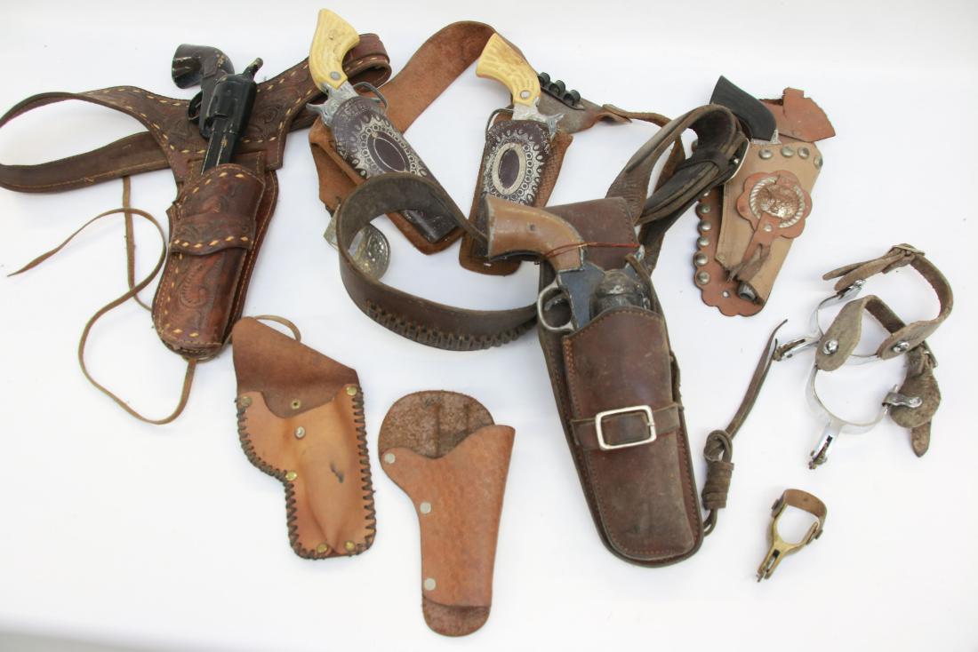 GROUP LOT OF TOY GUNS: CAP GUNS AND SOLID TOY GUNS WITH HOLSTERS