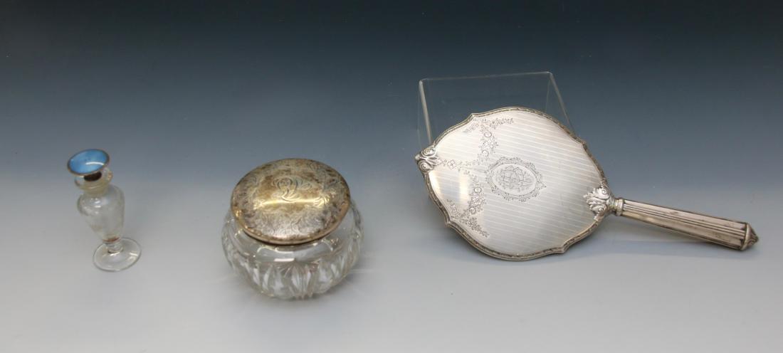 STERLING SILVER GROUP: STERLING HAND MIRROR WITH MONOGRAM, STERLING CUT GLASS POWDER JAR AND A STERLING AND ENAMEL PERFUMER Dimensions: 12" X 5" MIRROR - 3 1/4" X 4 1/2" JAR - 4 1/4" PERFUMER