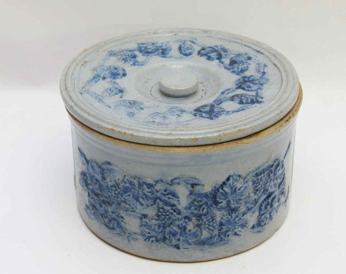 STONEWARE CAKE CROCK: BLUE EMBOSSED STONEWARE CROCK WITH LID - DEPICTS GRAPE AND GRAPE LEAVES - MARKED ON BOTTOM "ROBINSON CLAY PRODUCT, AKRON, OHIO" Dimensions: 10" X 5 1/4"