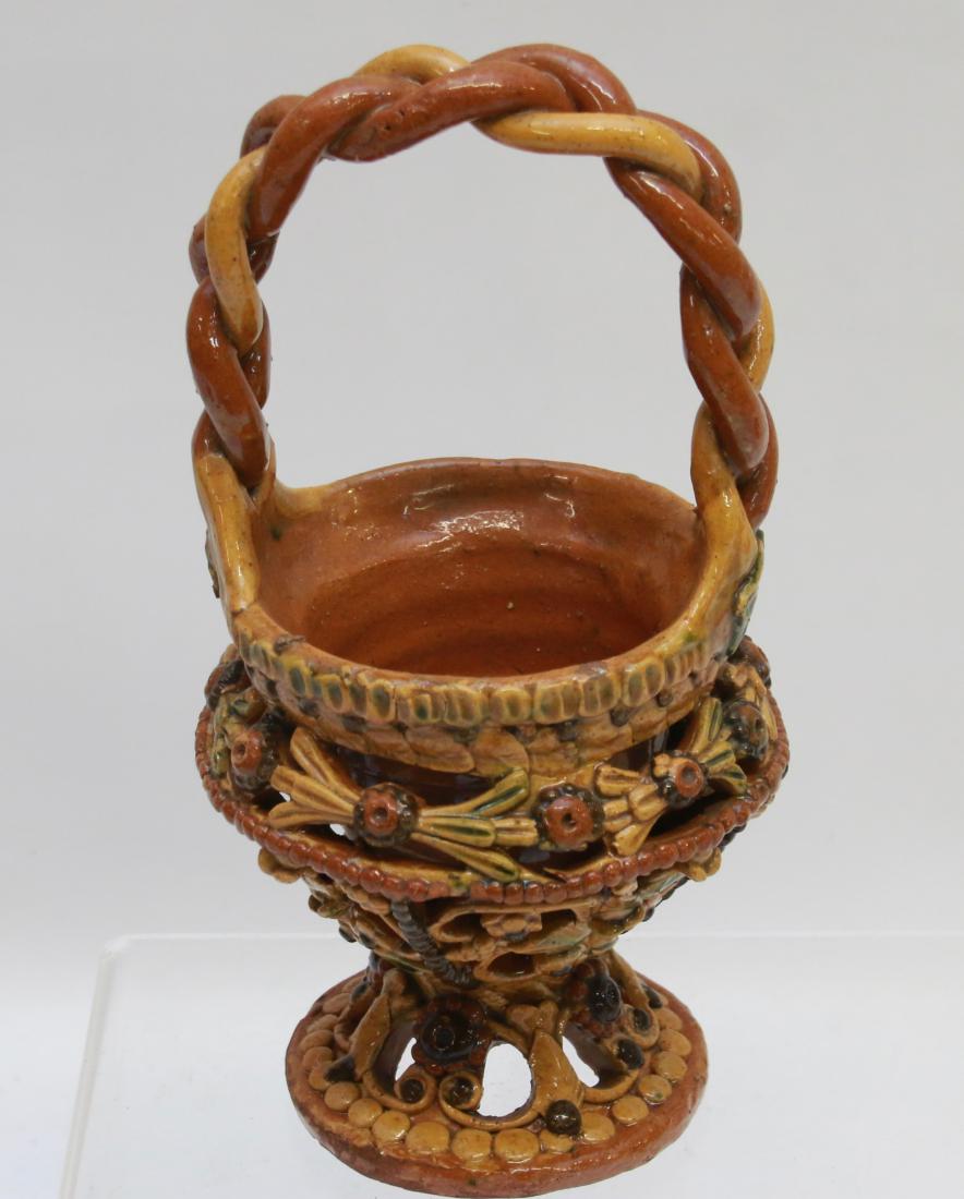 REDWARE BASKET: POTTERY OPENWORK BASKET WITH MULTI COLOR GLAZE - WOVEN HANDLE WITH FLORAL MOTIF THROUGHOUT Dimensions: 8" H X 4 1/2"