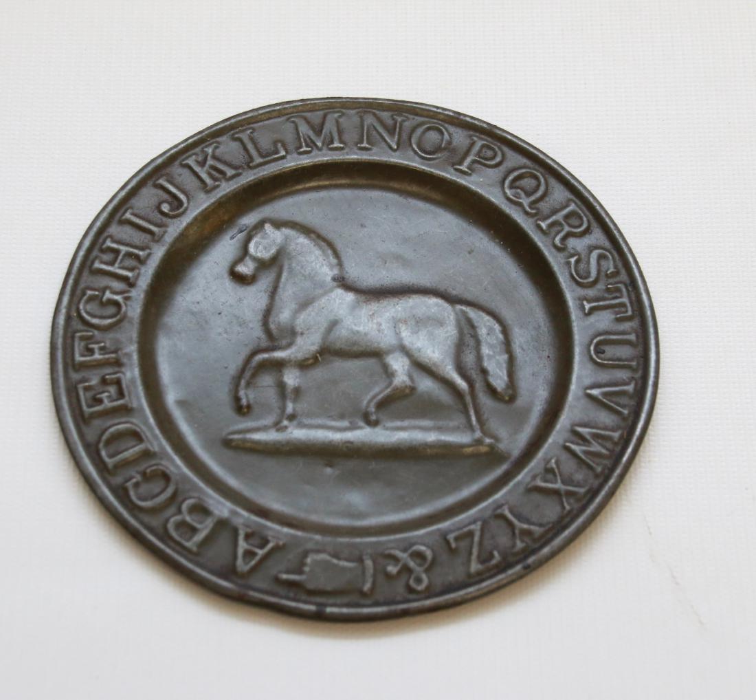 TIN ALPHABET PLATE: CHILDS ABC PLATE WITH EMBOSSED HORSE IN CENTER Dimensions: 5 1/2" DIAMETER