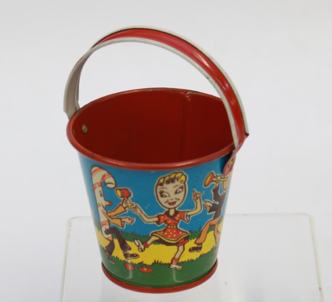 TIN LITHO SAND PAIL: MARKED " U.S. METAL TOY" MUSICIANS AND DANCERS Dimensions: 3"