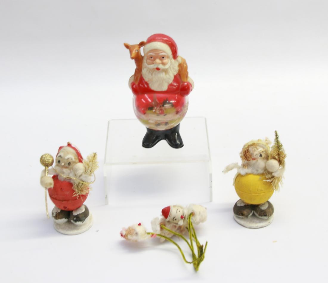 GROUP LOT OF CHRISTMAS ITEMS: (4) INCLUDING - PLASTIC SANTA SNOW GLOBE - GROUP OF SANTAS ON GREEN STEMS - TWO SANTA SANTA FIGURES Dimensions: 3 1/2" TO 5 1/2"