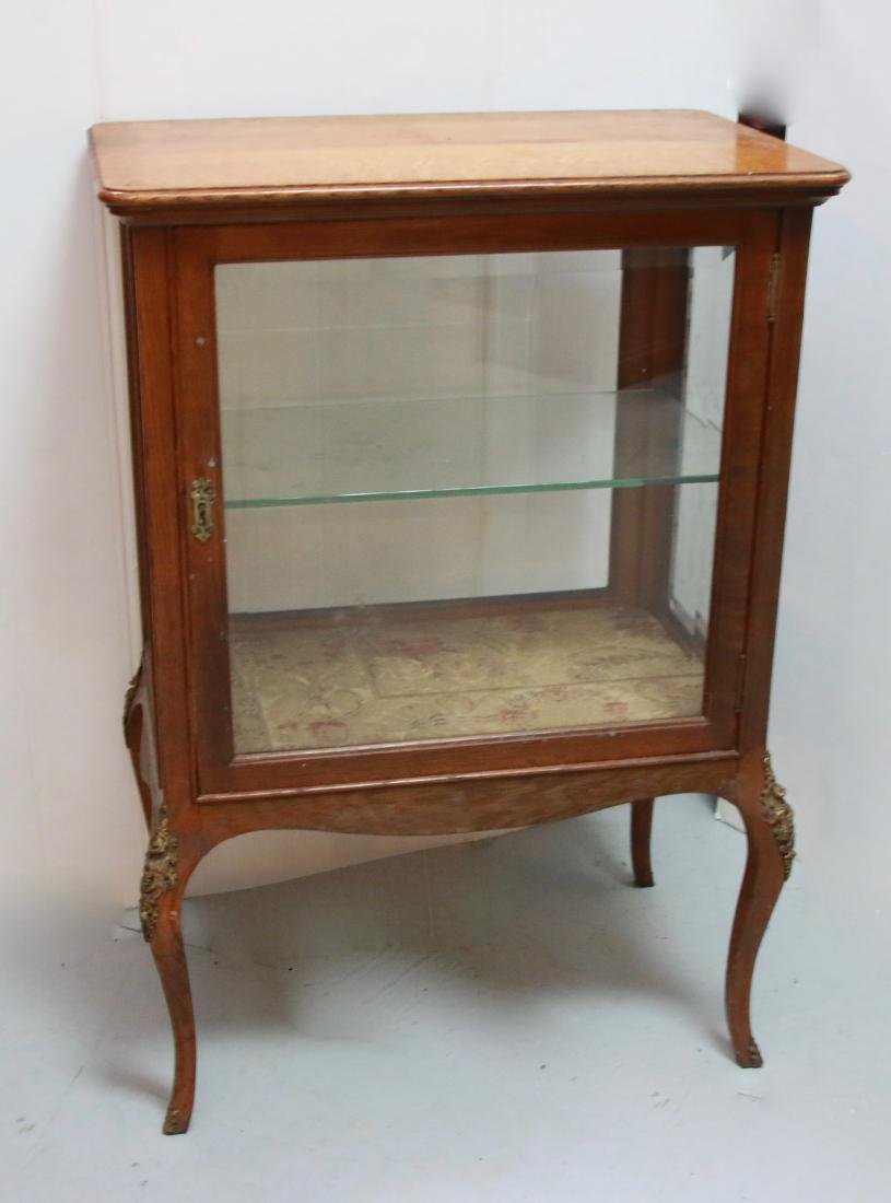 OAK CURIO CABINET: OAK CURIO CABINET WITH BEVELED GLASS AND BRASS ORMOLU ON LEGS , 28" X 18" X 40"