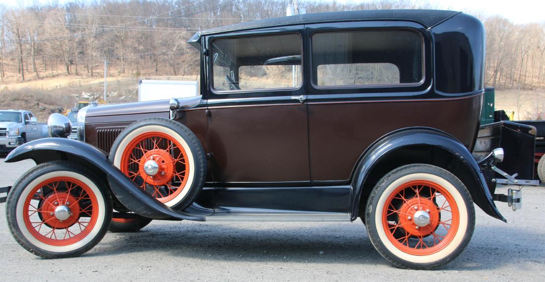 1930 FORD MODEL "A" 2 DOOR SEDAN: 74,429 MILES - BROWN WITH BLACK FENDERS - MAUVE CLOTH INTERIOR - OLDER RESTORATION - TRUNK MOUNTED ON REAR - METAL SPOKE WHEELS - SPARE TIRE LEFT FRONT FENDER - WHITE WALL TIRES (4.75/5.00/5.25/5.50 X