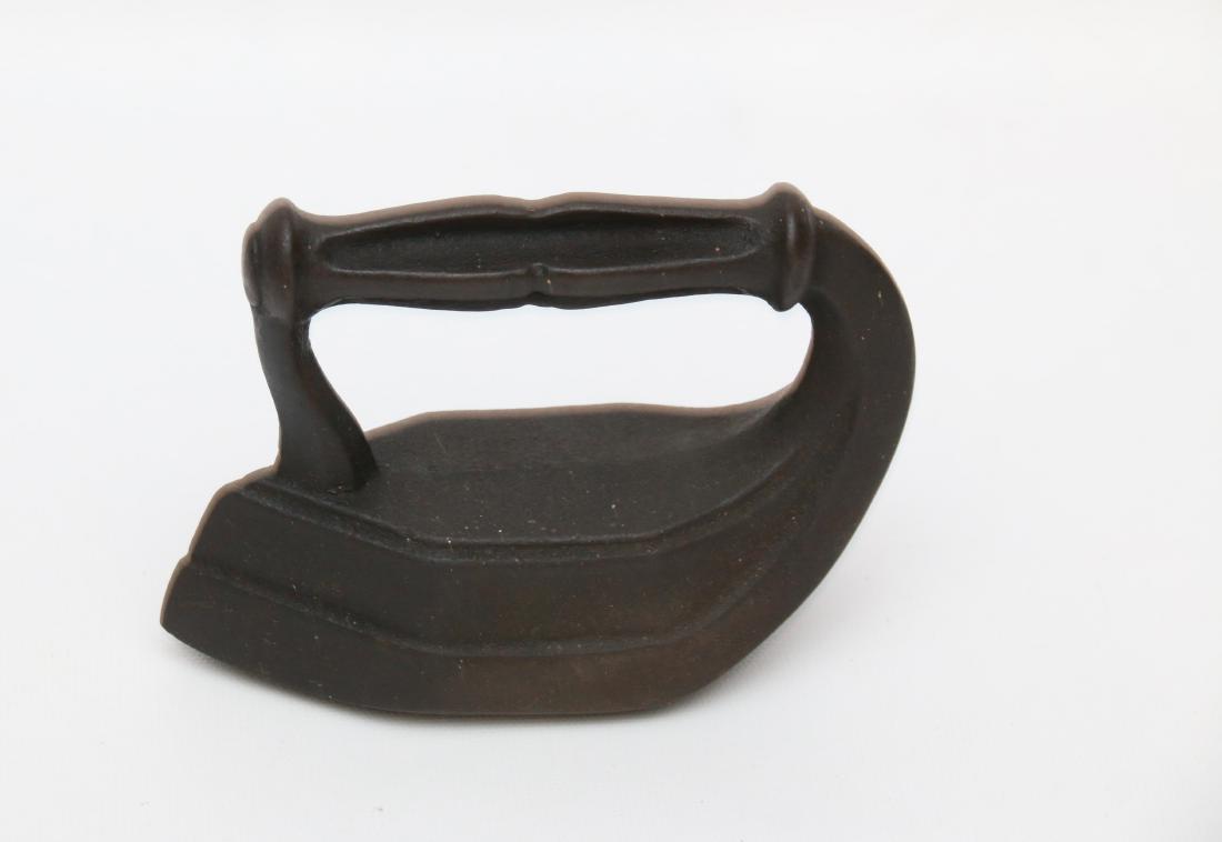 POLISHING IRON: CAST POLISHING IRON IN "ODD" SHAPE. 5"