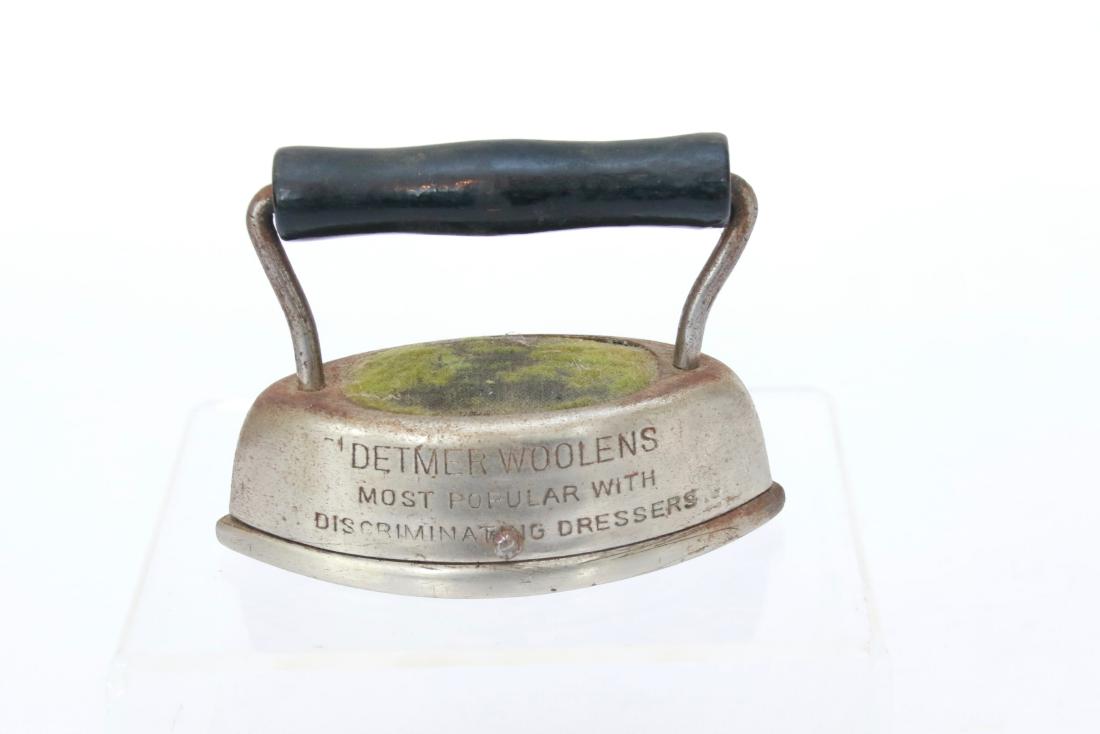 ADVERTISING PIN CUSHION: IN THE FORM OF AN IRON - DETMER WOOLENS "MOST POPULAR WITH DISCRIMINATING DRESSERS". 4 1/8"