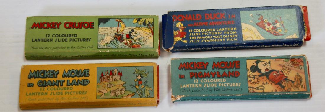 GROUP OF WALT DISNEY SLIDES: (12) COLORED SLIDES IN EACH PACK - TITLES INCLUDE - "MICKEY MOUSE IN PIGMYLAND" - "MICKEY CRUSOE" - "MICKEY MOUSE IN GIANTLAND" - "DONALD DUCK IN AN ALPINE ADVENTURE" - MADE IN ENGLAND BY; ENSIGN LIMI