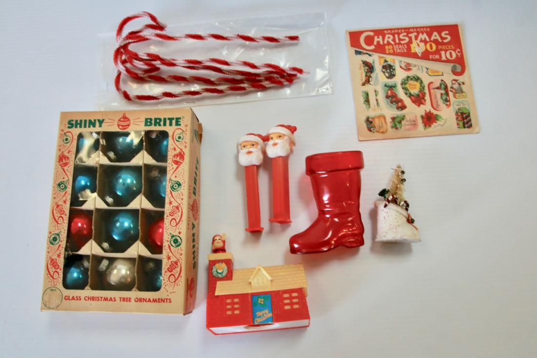 GROUP LOT OF CHRISTMAS DECORATIONS: INCLUDING - BOX OF SHINY BRITE BALLS, CHRISTMAS SEALS, (2) PEZ DISPENSERS, (2) BOOTS, PLASTIC BANK, AND PIPE CLEANER CANDY CANES