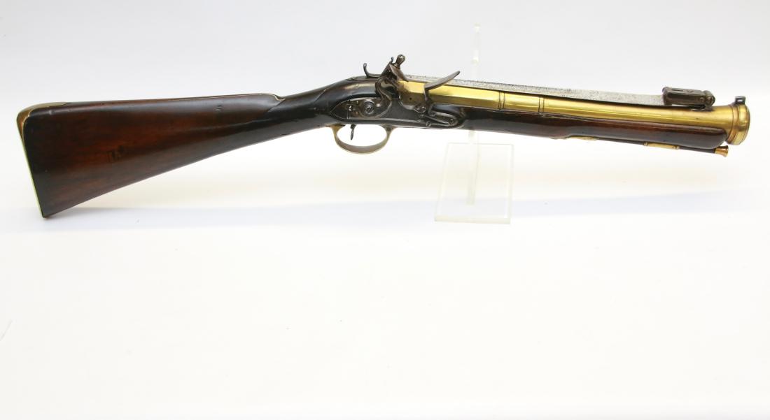 ENGLISH FLINTLOCK BLUNDERBUST W/ BAYONET: LOCK IS MARKED "BENNETT" - BRASS BARREL MARKED "ROYAL EXCHANGE, LONDON" - STOCK HAS A FEW SMALL CRACKS - FOLDING BAYONET FUNCTIONS PROPERLY - 29 1/2" L
