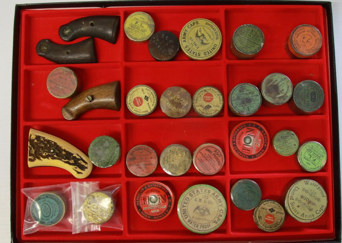 ANTIQUE AND VINTAGE PERCUSSION CAPS AND TINS: ANTIQUE AND VINTAGE PERCUSSION CAPS AND TINS, ALSO ASSORTED VINTAGE PISTOL GRIPS - (25) TOTAL TINS WITH CAPS