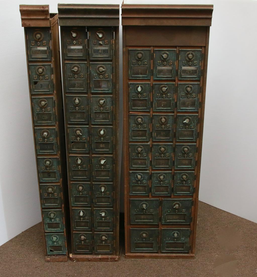 GROUP OF METAL POST OFFICE BOXES: THREE SECTIONS. FORTY-THREE BOXES WITH GLASS INSERTS IN DOORS