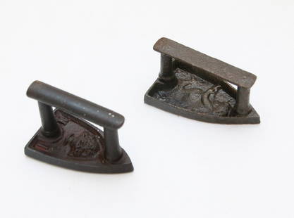 PAIR OF FRENCH SAD IRONS: SMALL SIZE - ONE WITH FLOWER BASKET DESIGN OTHER WITH BABY Size: 2 1/2" AND 3"