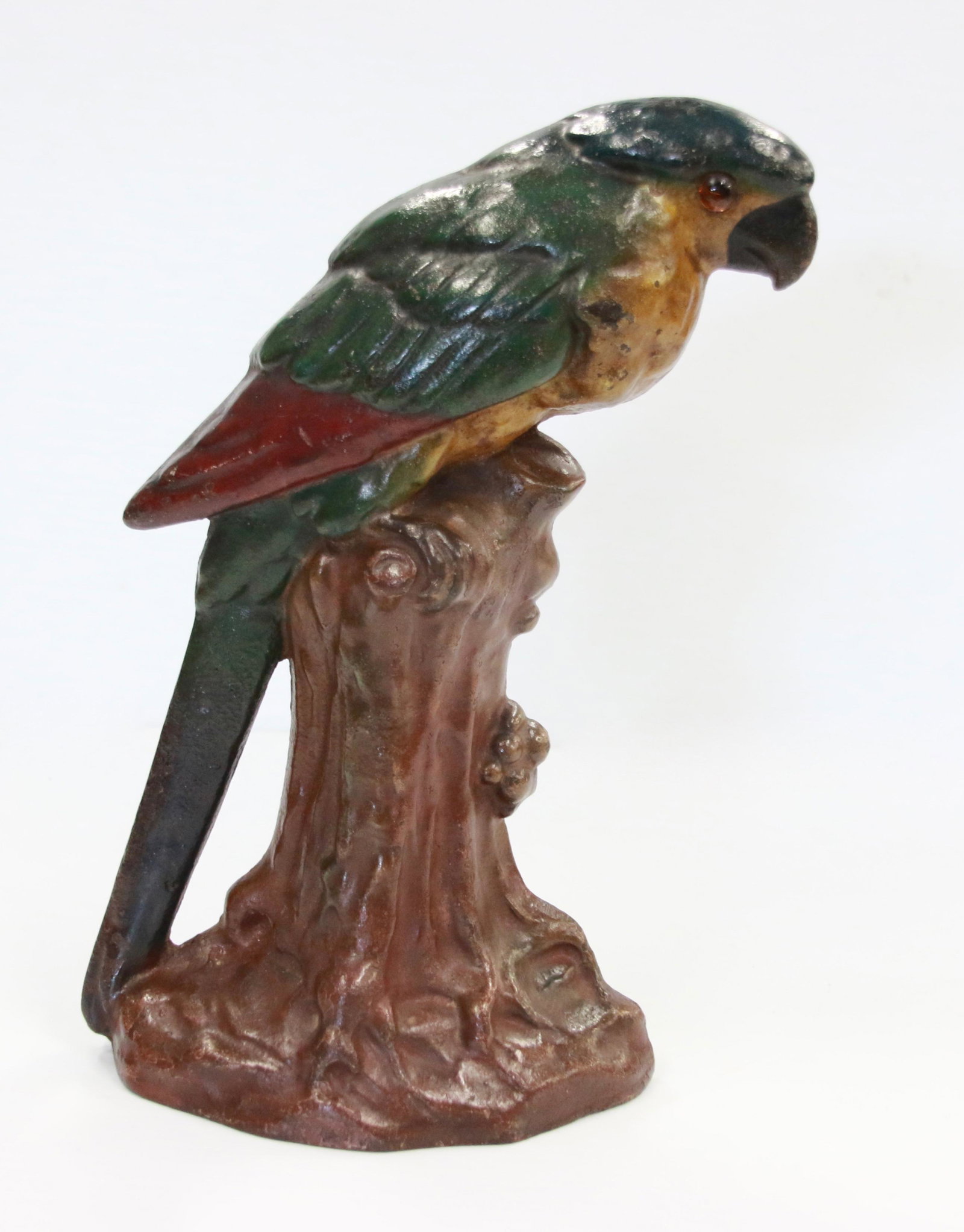 19TH CENTURY CAST IRON PARROT DOORSTOP: LATE 19TH CENTURY PARROT ON A STUMP DOORSTOP IN ORIGINAL PAINT WITH GLASS EYE - FOUNDRY MARKINGS ON BACK Size: 10 3/8" H